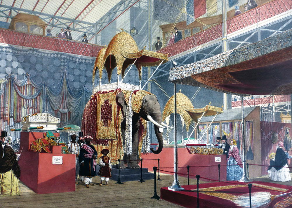 An 1851 lithograph showing the Indian display at the Crystal Palace Great Exhibition, featuring a massive taxidermy elephant under a golden canopy surrounded by Victorian visitors.