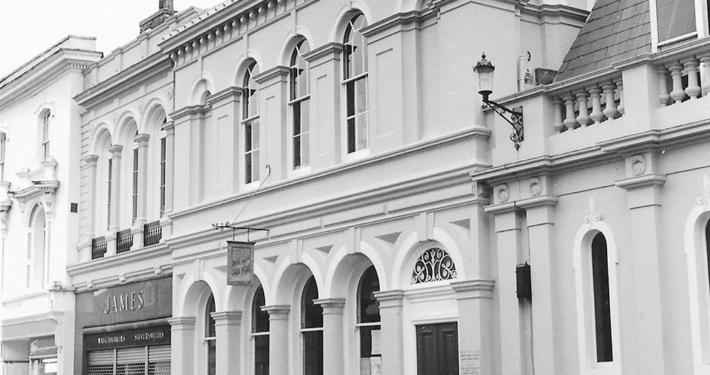 A black and white image of the Saffron Walden Gibson Library building.