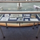A Gibson Library exhibition display cabinet featuring various books and exhibition cards